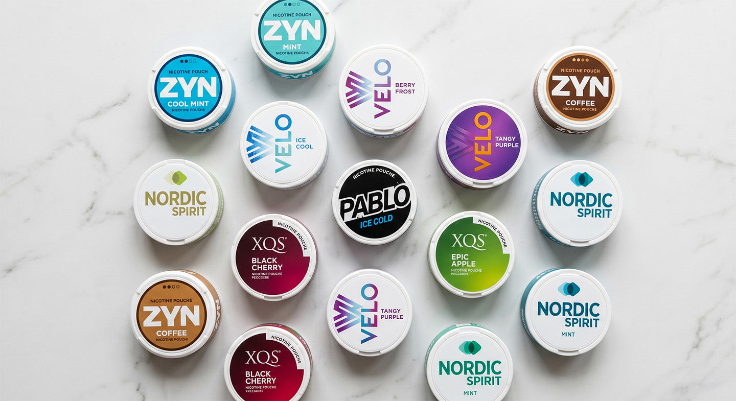 Selection of Nicotine Pouch cans on a marble surface